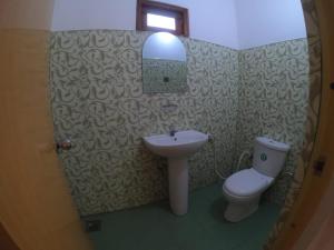 a bathroom with a sink and a toilet at Punkalasa tourist lodge in Anuradhapura