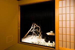 a fireplace in a room with rocks in it at Hotel ZIZI Kyoto Gion in Kyoto