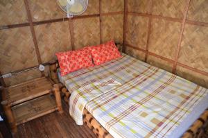 A bed or beds in a room at Coron Backpacker Guesthouse