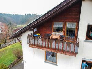 a house with a balcony with a table on it at Monteurzimmer Hochsal in Laufenburg