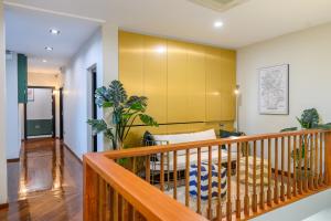 a living room with a yellow wall at KLYDE Boutique - Chatuchak in Bangkok