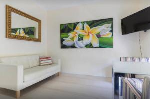 a living room with a white couch and a tv at M102 West Perth Studio Apartment near Kings Park in Perth