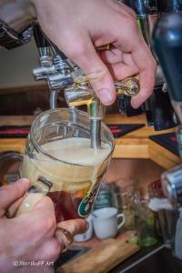 a person is pouring coffee into a glass at Hotel Almaz in Poltava