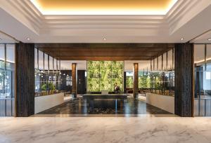 a lobby with a fountain in the middle of a building at Luminor Hotel Tanjung Selor By WH in Tanjungselor