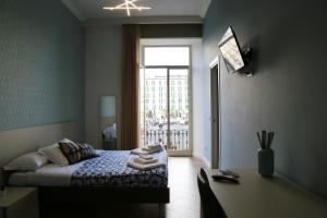 a small bedroom with a bed and a window at Garibaldi Rooms in Naples
