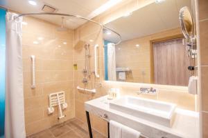 a bathroom with a sink and a shower at Holiday Inn Ulaanbaatar, an IHG Hotel in Ulaanbaatar