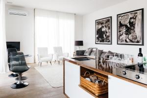 a living room filled with furniture and a large window at Riva Lofts Florence in Florence