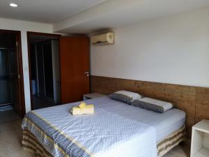 Un dormitorio con una cama con una toalla. en Flat Mar do Cabo Branco Residence, en João Pessoa