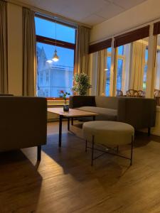 a living room with a couch and a table at Rødberg Hotel in Rødberg