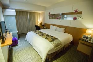Postel nebo postele na pokoji v ubytování Ximen Relite Hotel