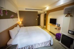Postel nebo postele na pokoji v ubytování Ximen Relite Hotel