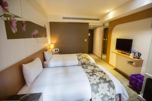 Postel nebo postele na pokoji v ubytování Ximen Relite Hotel