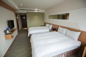 Postel nebo postele na pokoji v ubytování Ximen Relite Hotel