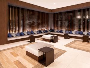 a lobby with couches and tables in a building at La'gent Stay Hakodate Ekimae in Hakodate +83 photos