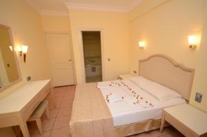 a bedroom with a bed with a cake on it at alenz suite in Marmaris