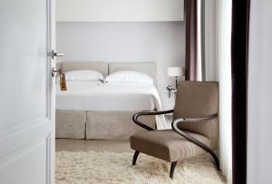a white bed sitting in a room next to a door at Riva Lofts Florence in Florence