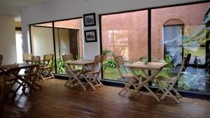 a group of tables and chairs in a room at SAHA NOFY Ambohimalaza Guest in Antananarivo