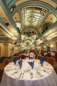 a dining room with a table with plates and silverware at The Savoy Hotel Adults Only in Blackpool