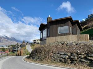 a house on top of a rock on a road at GoldRush Haven in Queenstown