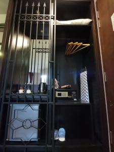 a black cabinet with a microwave in it at Kimberley Hotel Georgetown in George Town