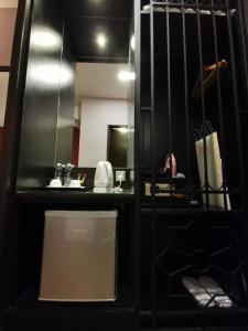 a bathroom with a sink and a mirror at Kimberley Hotel Georgetown in George Town