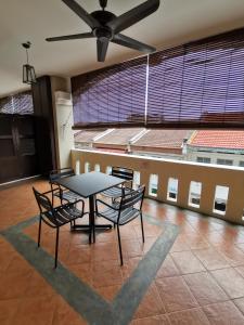 a table and chairs in a room with a ceiling at Kimberley Hotel Georgetown in George Town