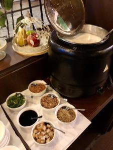 a buffet with bowls of food on a table at Kimberley Hotel Georgetown in George Town