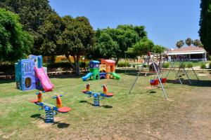 a group of playground equipment in a park at Makronisos Village in Ayia Napa