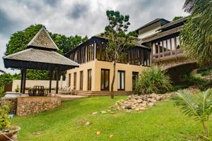 a house with a gazebo in a yard at Pawanthorn Samui - SHA Plus in Chaweng