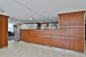 a room with wood paneled walls and a kitchen at Qasr Al Hamra ApartHotel Al Hamra Branch in Jeddah