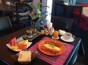 a table with a plate of breakfast food on it at iuDia Hotel in Phra Nakhon Si Ayutthaya