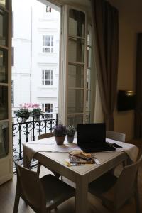 a laptop computer sitting on a table in a room at Napoli Mariana Luxury in Naples