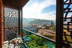 a balcony with a view of a city at KMM Hotel in Tbilisi City