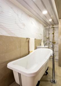 a bathroom with a tub and a sink at Selamod Village Guest House in Tshaneng