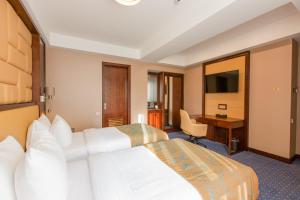 מיטה או מיטות בחדר ב-KMM Hotel