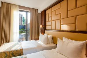 a hotel room with two beds and a window at KMM Hotel in Tbilisi City +62 photos