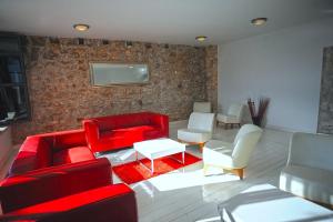 a living room with red furniture and white chairs at Unique villa Mojito with extra large pool in Rovinj for up to 12 persons, 6 bedrooms in Rovinj