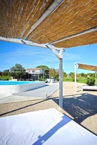 a view of a pool with a gazebo at Unique villa Mojito with extra large pool in Rovinj for up to 12 persons, 6 bedrooms in Rovinj