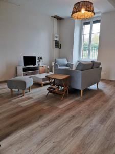 a living room with a couch and a table at Maison de campagne à 1h20 de PARIS in Saint-Hilaire-les-Andrésis