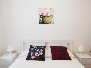 a bedroom with a bed with two pillows on it at City center apartment in Umag