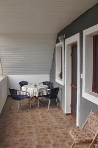 a patio with a table and chairs in a room at Natalia Vendeghaz in Balatonakali