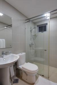 a bathroom with a shower and a toilet and a sink at CASAMIA Colombo @ On Three20 in Colombo