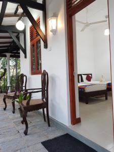 a living room with two chairs and a couch at The Waves Beach Chalets in Tangalle