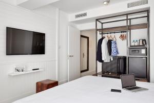 a room with a bed and a laptop on a table at Delamar 4*Sup-Adults only (18+) in Lloret de Mar