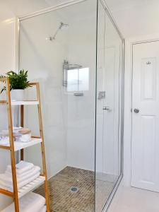 a shower stall with a glass door in a bathroom at Glen Iris, Quiet Boutique 2 bedroom Netflix, WIFI, Parking, Free Wine in Melbourne