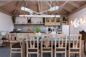 a kitchen with a dining room table and chairs at Willa Ewa in Łeba