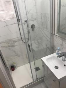 a bathroom with a shower and a sink at Tra le Torri B&B - Ampia stanza privata in appartamento con bagno privato accessibile da corridoio in Bologna