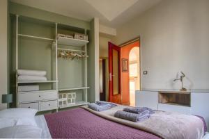 1 dormitorio con 1 cama con toallas en La maison du boulevard, en Aosta