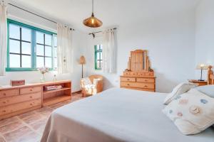 a bedroom with a bed and a dresser and window at Viv Vac La Casita del Viejo in Guía de Isora +21 photos