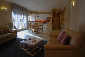 a living room with a couch and a table at La maison du boulevard in Aosta